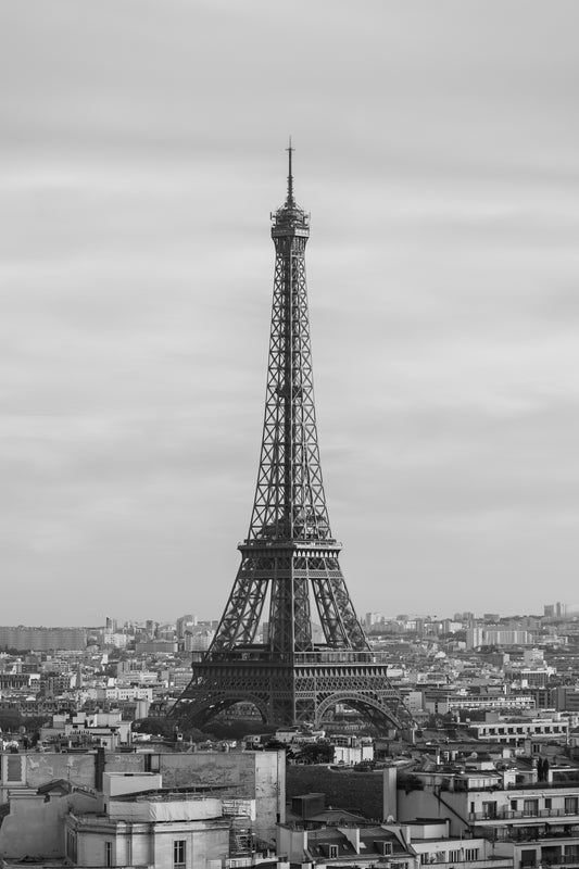 Black and White of Eiffel Tower with nearby city view.